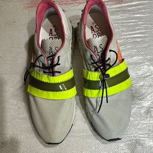 As98 tennis shoes. Greyish material with green and dark green band